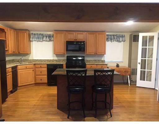 39 Sled Road Ashburnham, MA 01430 - Photo 6 of 23 a kitchen with granite countertop a stove top oven a sink a dining table and chairs