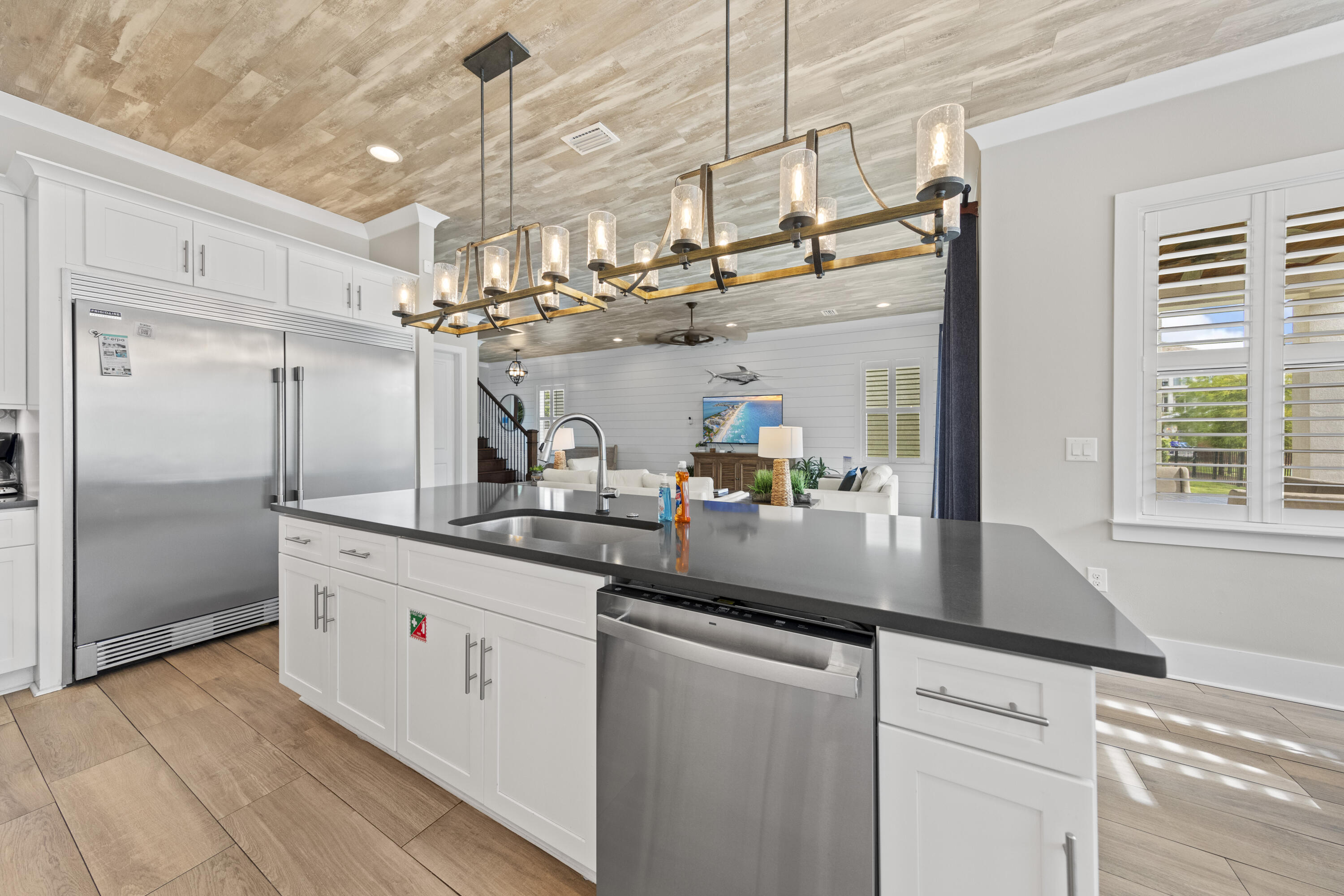 43 Calla Way Miramar Beach, FL 32550 - Photo 18 of 59 a kitchen with stainless steel appliances granite countertop a sink a refrigerator and a wooden floor