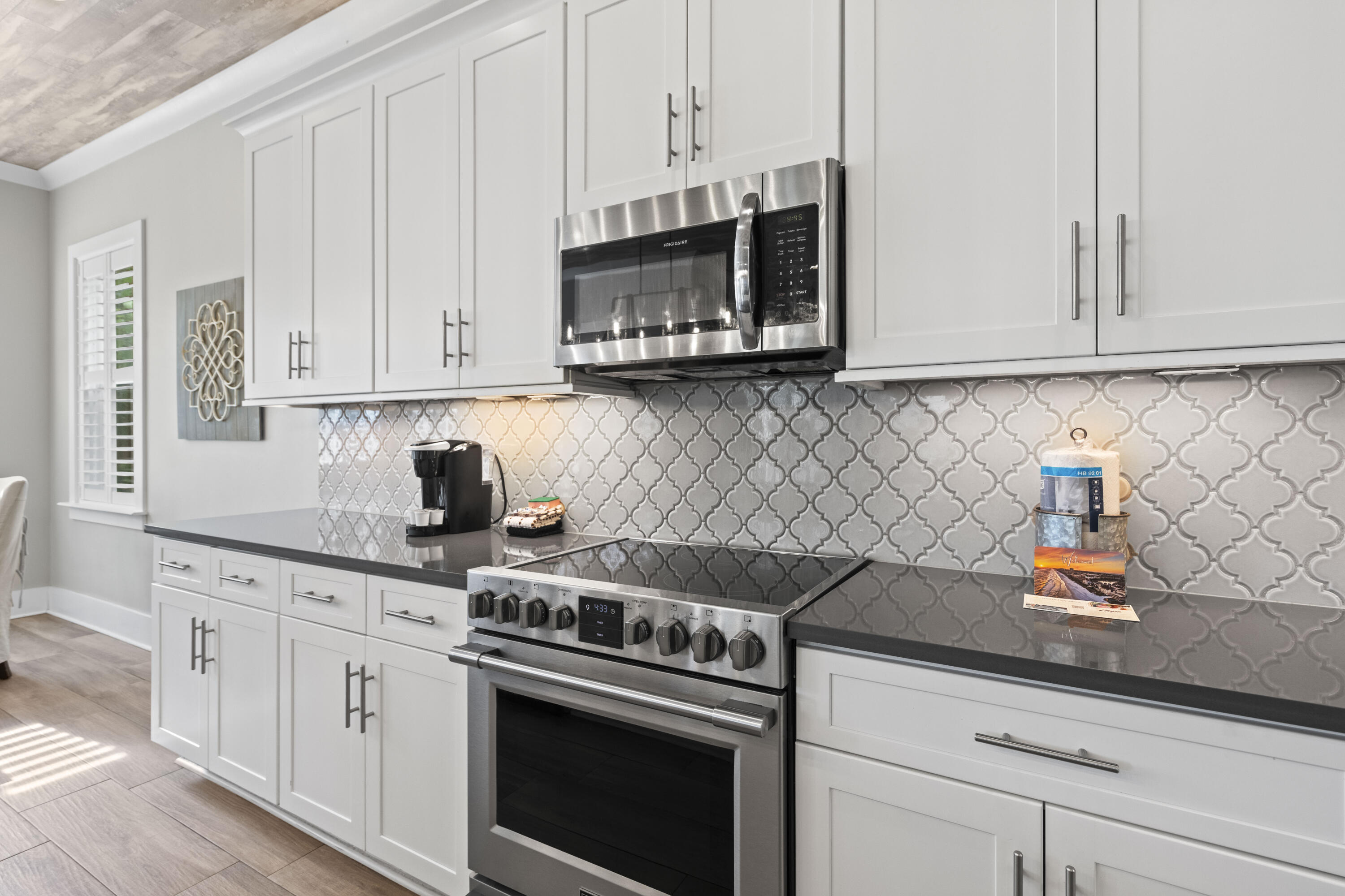 43 Calla Way Miramar Beach, FL 32550 - Photo 19 of 59 a kitchen with stainless steel appliances granite countertop a sink a stove and a microwave