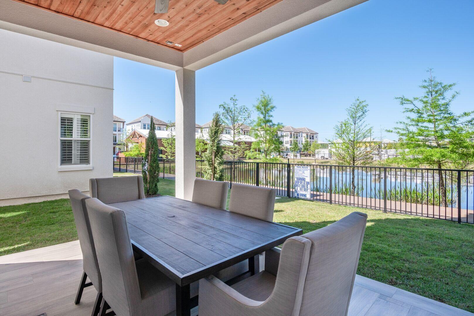 43 Calla Way Miramar Beach, FL 32550 - Photo 21 of 59 a view of a patio with table and chairs potted plants with wooden floor and fence