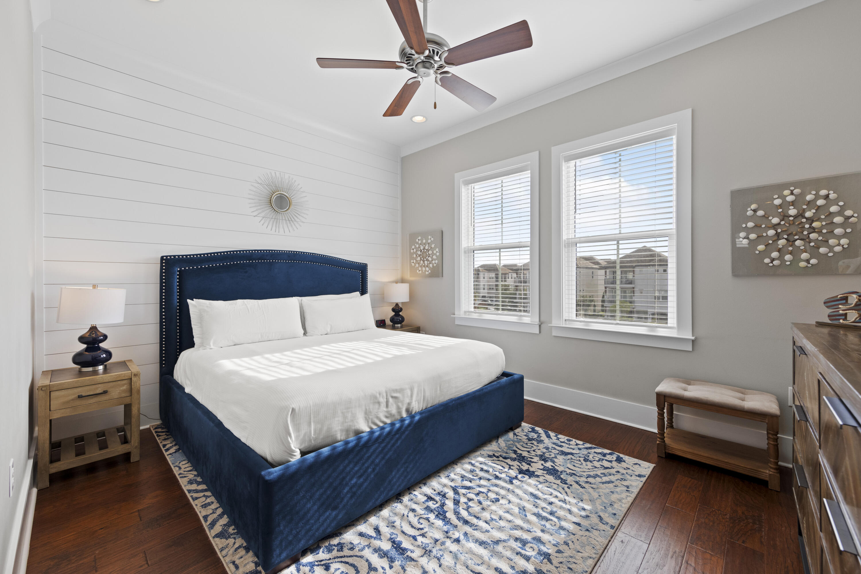 43 Calla Way Miramar Beach, FL 32550 - Photo 48 of 59 a bedroom with a bed a dresser and wooden floor