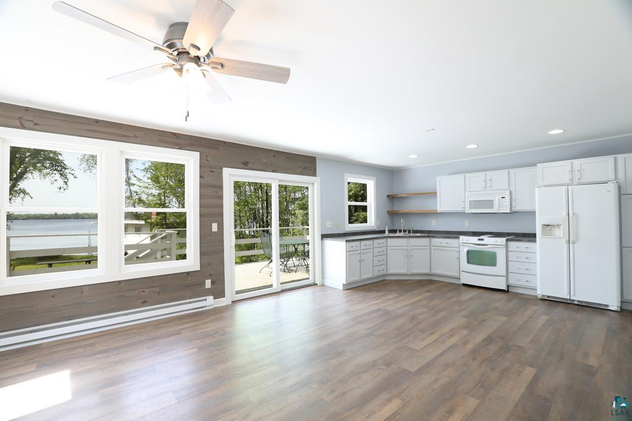 3739 Sundling Road Tower, MN 55790 - Photo 2 of 15 Kitchen with a baseboard radiator, ceiling fan, dark wood-type flooring, white cabinets, and white appliances