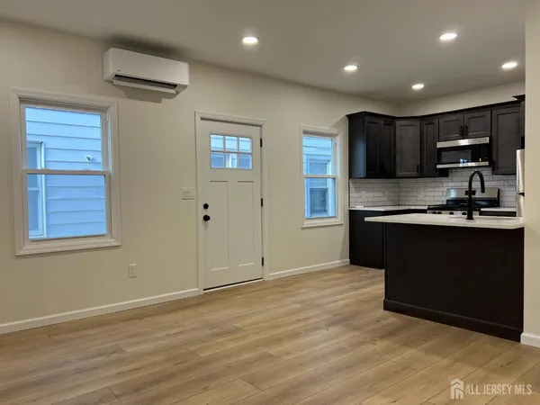 a kitchen with stainless steel appliances a refrigerator stove and kitchen island
