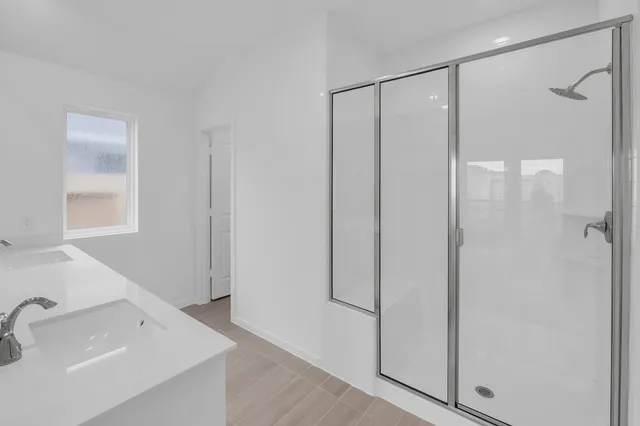a view of a bathroom with two sinks and a bathtub
