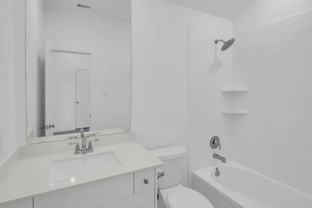 a bathroom with a double vanity sink a mirror a bathtub and shower