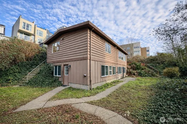 a view of house with backyard and garden