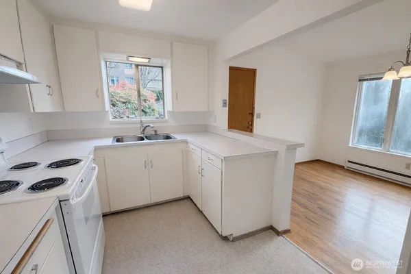 a utility room with cabinets washer and dryer