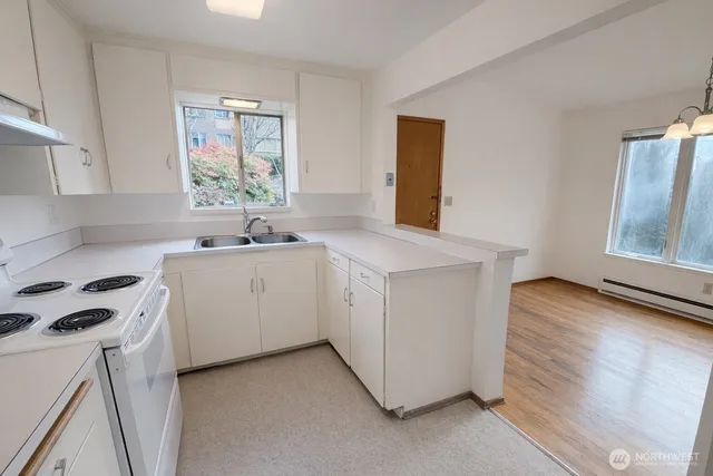 a utility room with cabinets washer and dryer