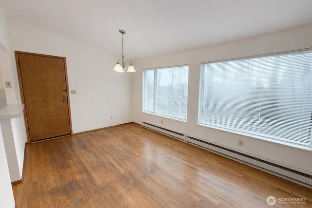 a view of a room with window wooden floor and door