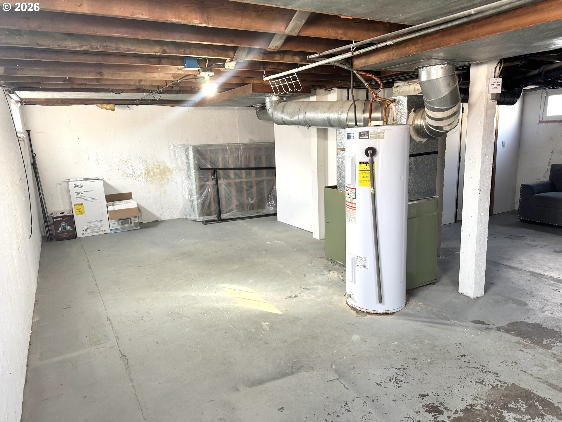 2243 3rd Street Baker City, OR 97814 - Photo 15 of 20 a view of water heater room with refrigerator