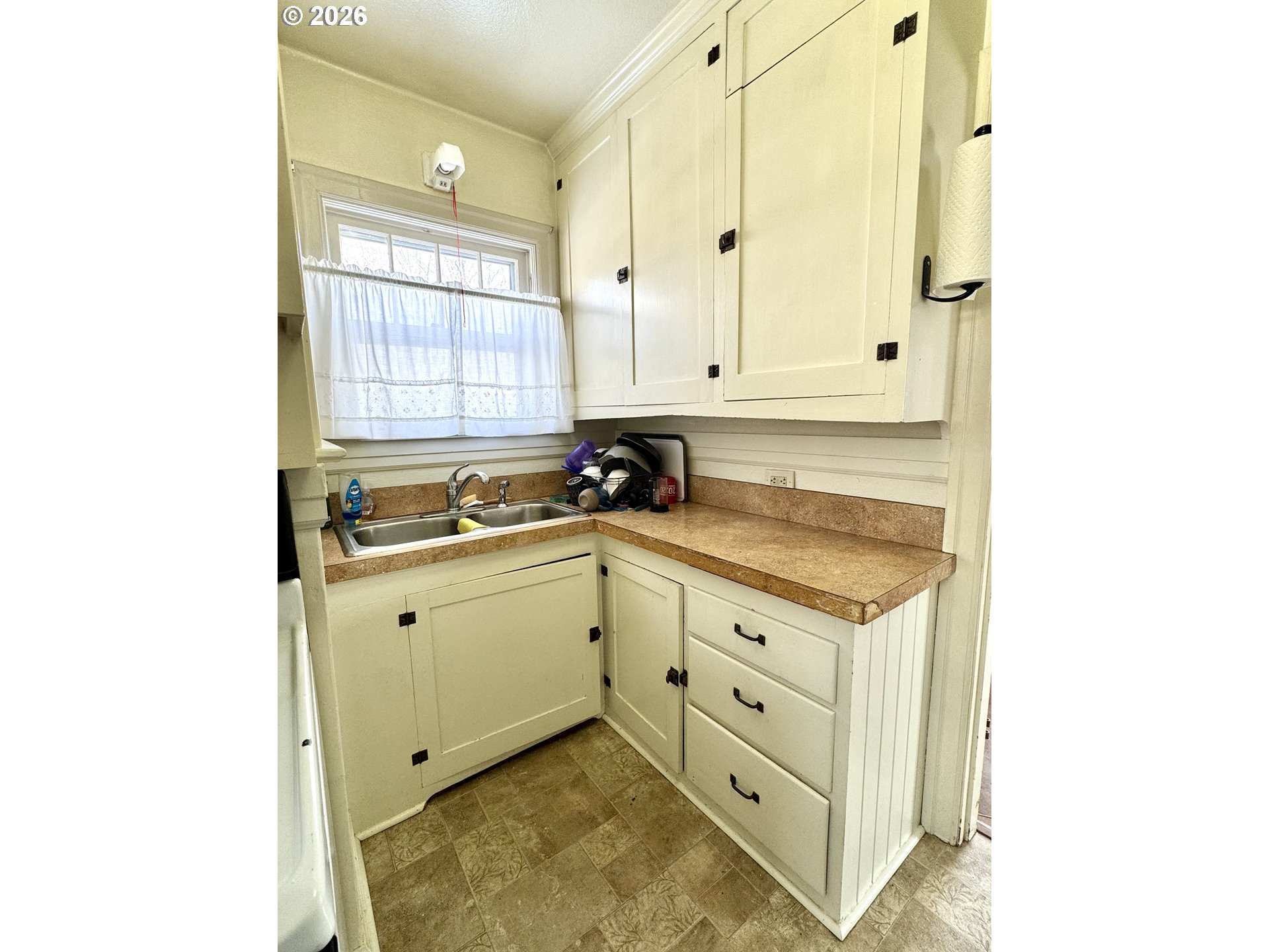 2243 3rd Street Baker City, OR 97814 - Photo 4 of 20 a view of a kitchen with white cabinets