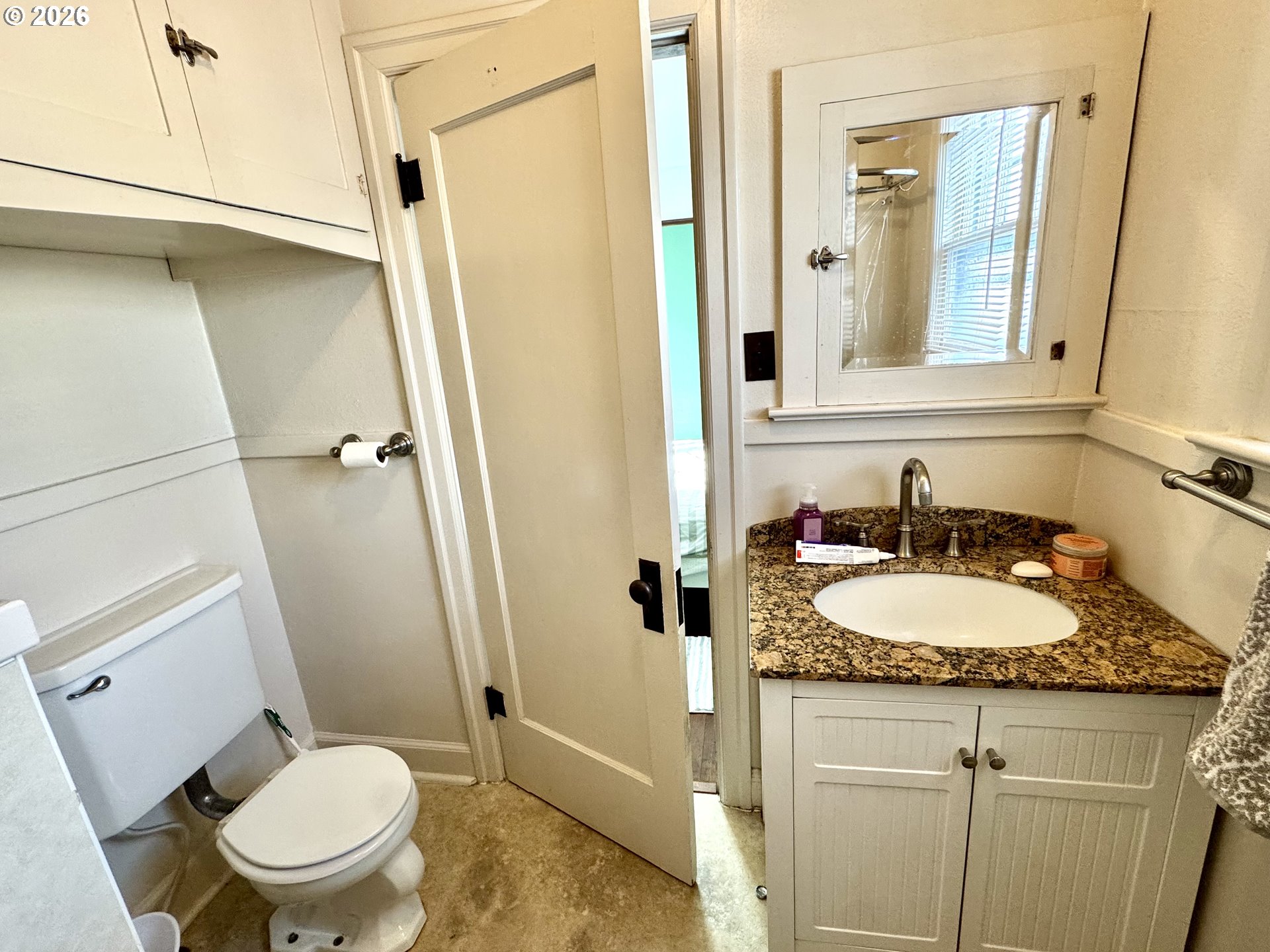 2243 3rd Street Baker City, OR 97814 - Photo 9 of 20 a bathroom with a granite countertop toilet sink and mirror