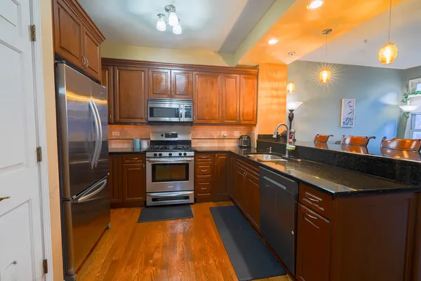 a kitchen with stainless steel appliances a refrigerator sink and cabinets