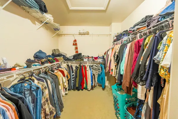 a view of walk in closet with clothes