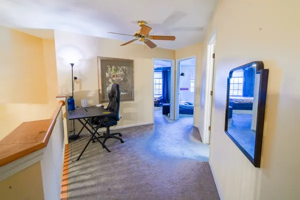 a view of a livingroom with furniture and a workspace