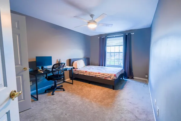 a bed room with a bed and a chair