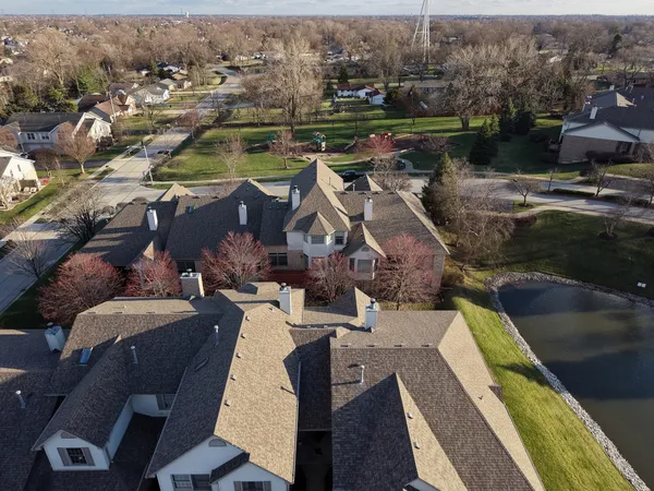 an aerial view of a house with a lake view