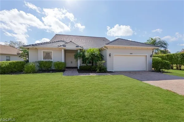 a front view of a house with a yard and garage