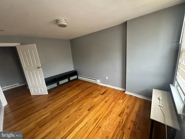 a view of a room with wooden floor and staircase