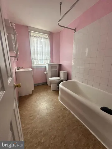 a bathroom with a bathtub sink and toilet