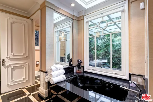 a living room with furniture and large windows