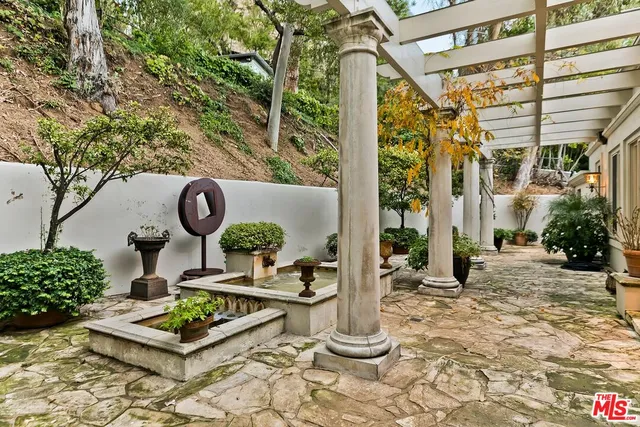 a front view of a house with garden and plants
