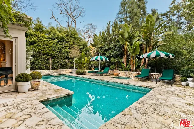 a view of a swimming pool with a lounge chair