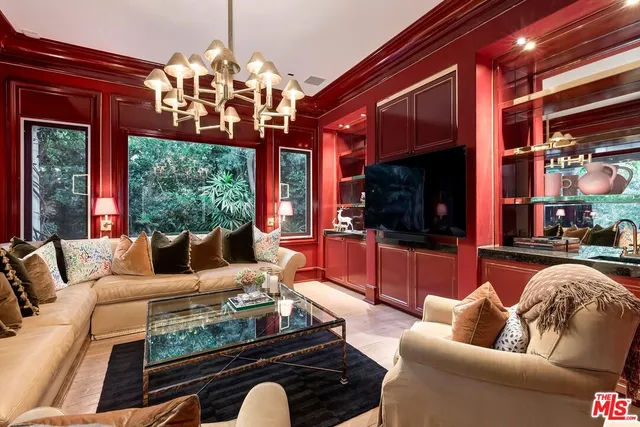 a living room with furniture a flat screen tv and a large window