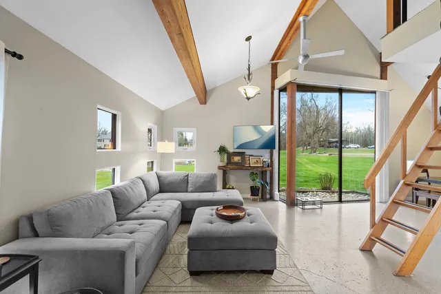 a dining room with wooden floor and stairs
