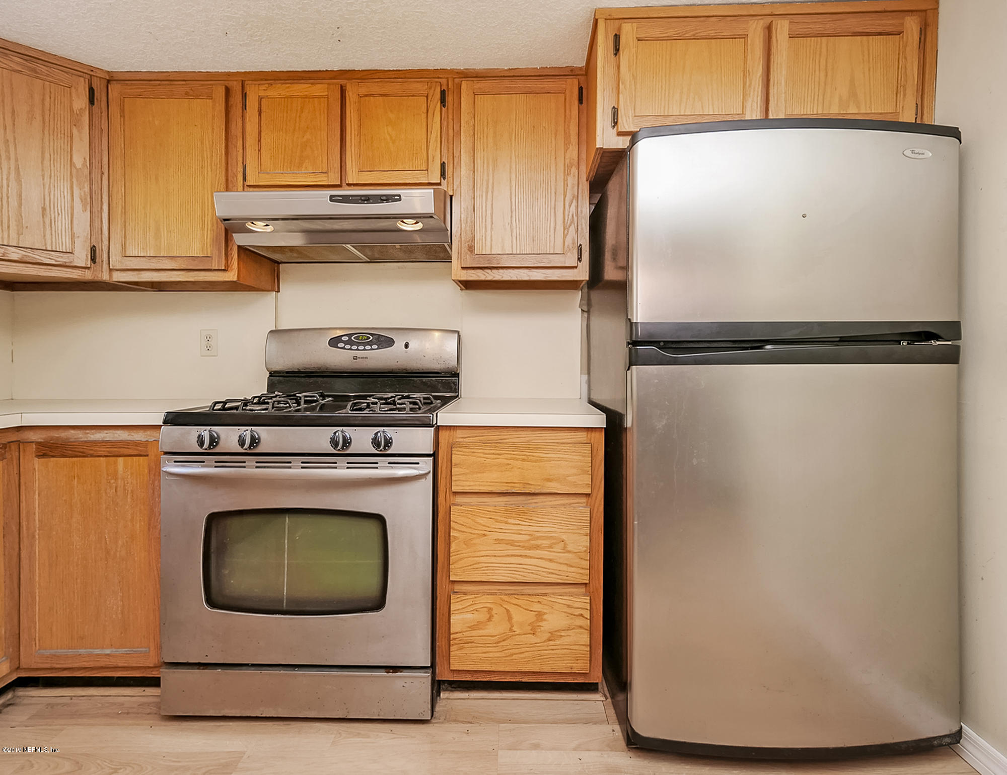 13143 Pate Road West Jacksonville, FL 32226 - Photo 9 of 23 a kitchen with refrigerator a stove and a microwave