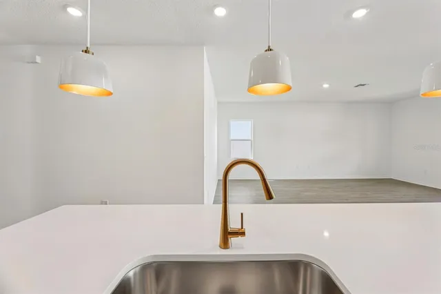 a kitchen with a sink and chandelier
