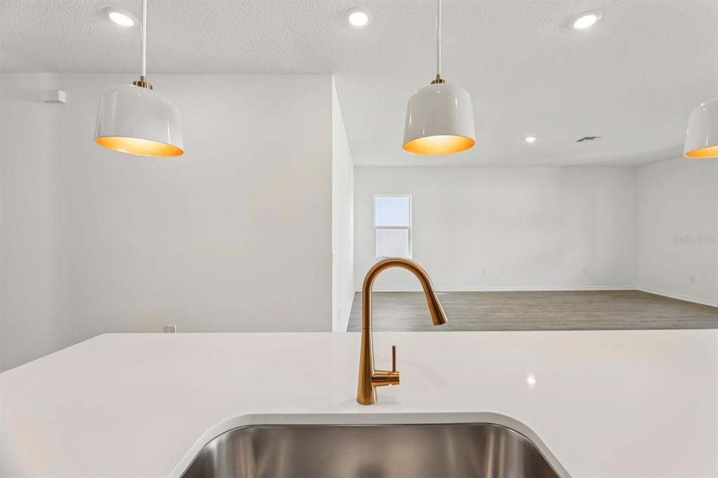 5721 Haystack Drive St. Cloud, FL 34771 - Photo 11 of 36 a kitchen with a sink and chandelier