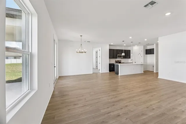 a view of a kitchen with a sink and a refrigerator