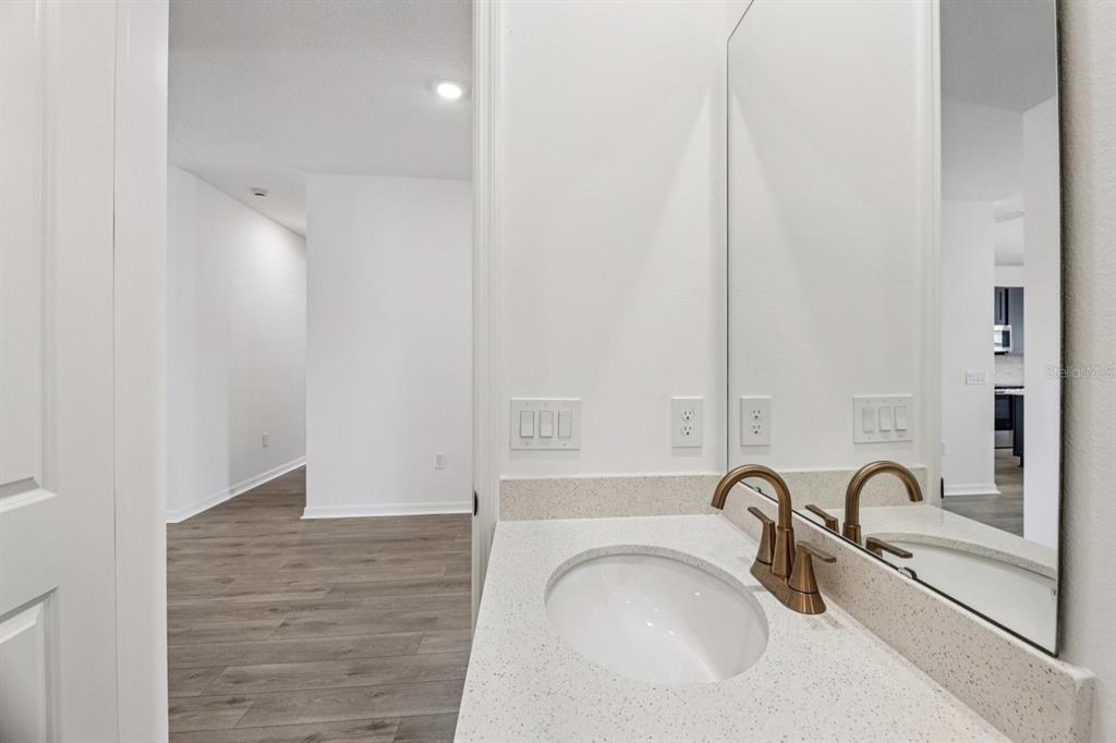 5721 Haystack Drive St. Cloud, FL 34771 - Photo 19 of 36 a bathroom with a sink and a mirror