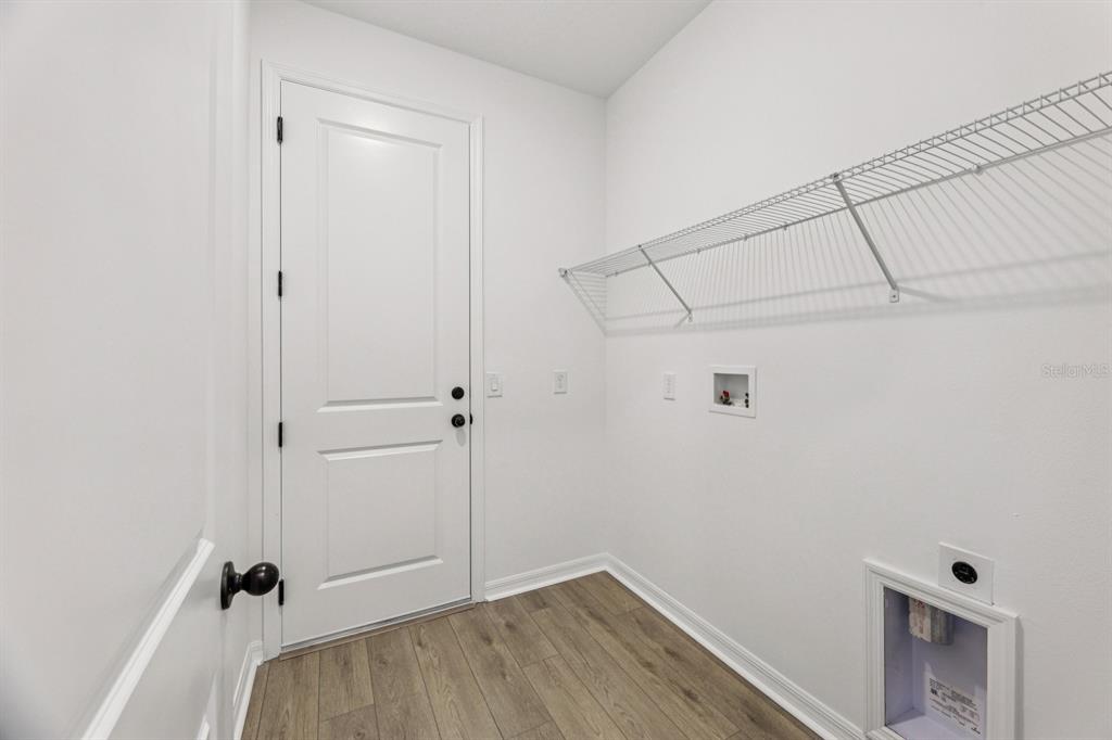 5721 Haystack Drive St. Cloud, FL 34771 - Photo 22 of 36 a view of a room with rack on the wall