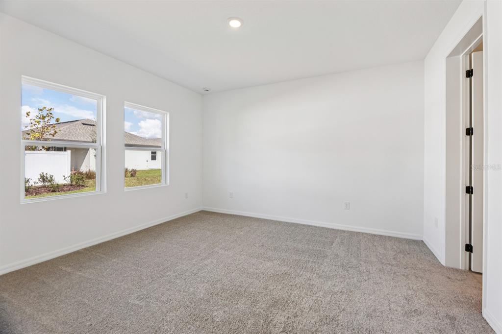 5721 Haystack Drive St. Cloud, FL 34771 - Photo 25 of 36 an empty room with windows and closet