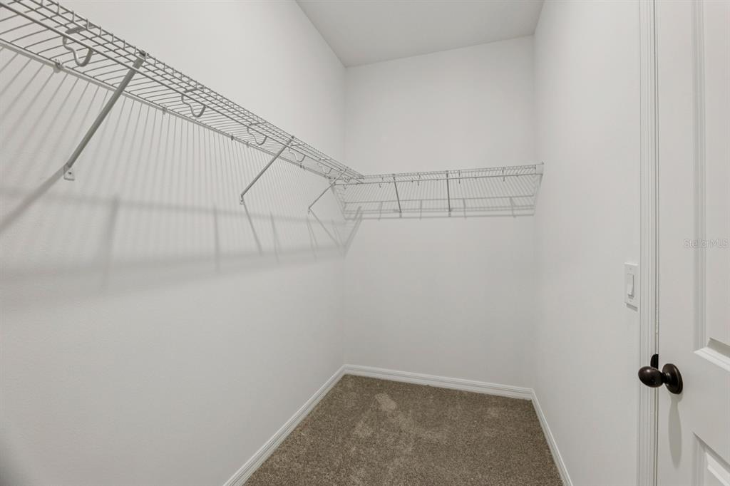 5721 Haystack Drive St. Cloud, FL 34771 - Photo 30 of 36 a view of a room with racks on the wall