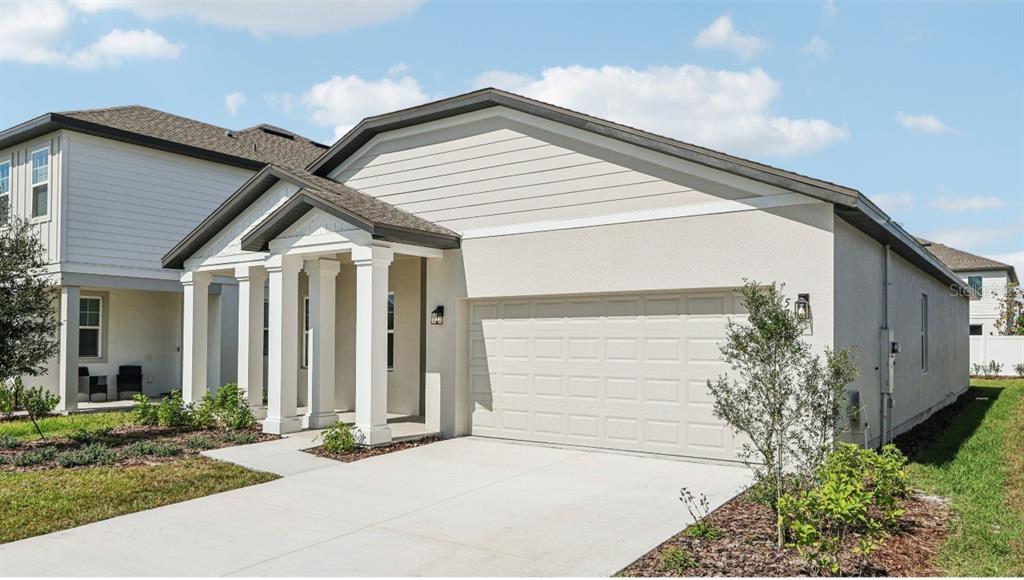 5721 Haystack Drive St. Cloud, FL 34771 - Photo 3 of 36 a front view of a house with a garden