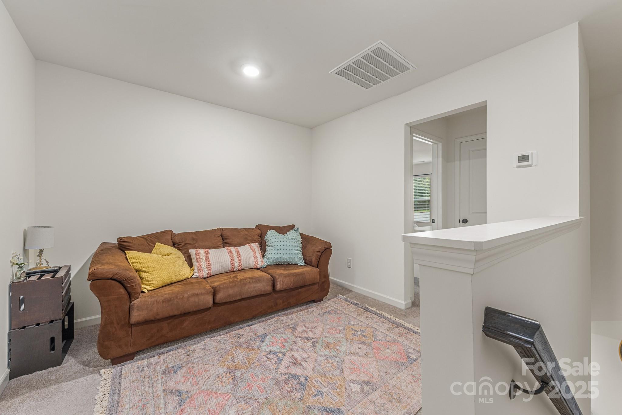 2038 Crooked Oak Lane, Unit 16 York, SC 29745 - Photo 13 of 24 a living room with furniture and a mirror