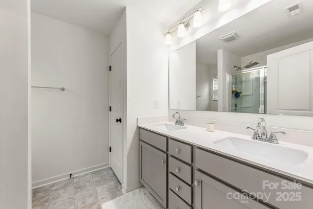 a bathroom with a double vanity sink and mirror