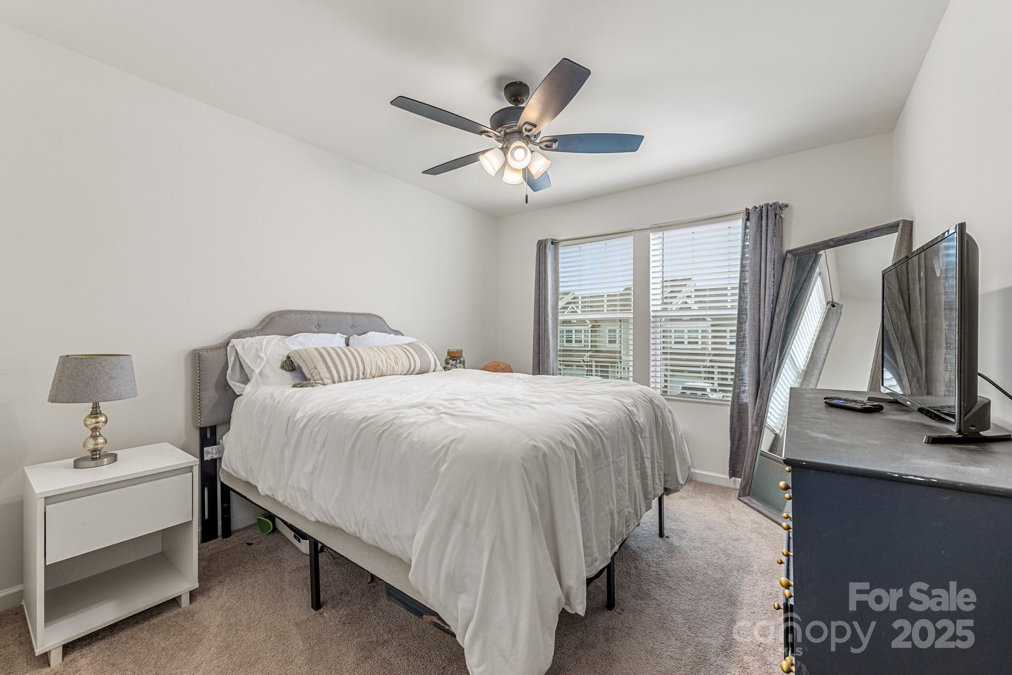 2038 Crooked Oak Lane, Unit 16 York, SC 29745 - Photo 19 of 24 a bedroom with a bed and a flat screen tv