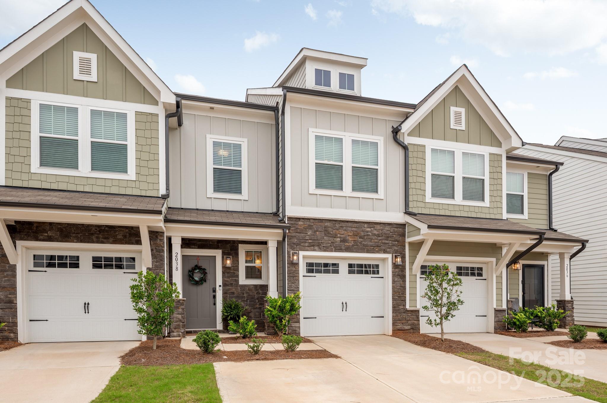 2038 Crooked Oak Lane, Unit 16 York, SC 29745 - Photo 2 of 24 a front view of a house with a yard and garage