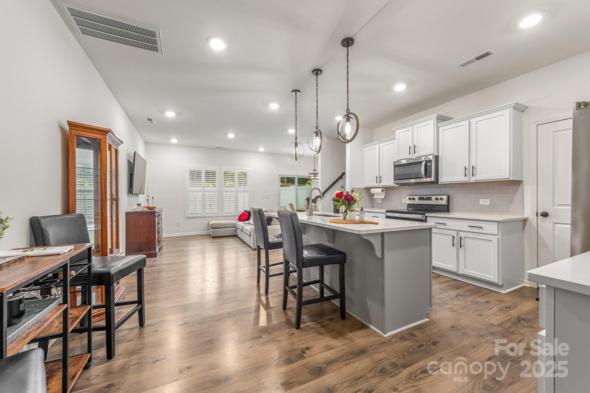 2038 Crooked Oak Lane, Unit 16 York, SC 29745 - Photo 7 of 24 a kitchen with white cabinets and chairs