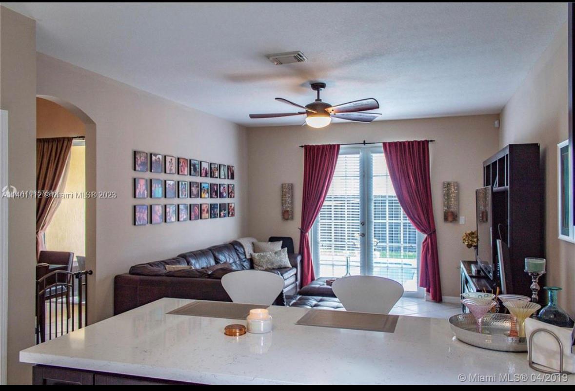 The Hammocks Miami, FL 33196 - Photo 3 of 9 a living room with furniture a window and a flat screen tv