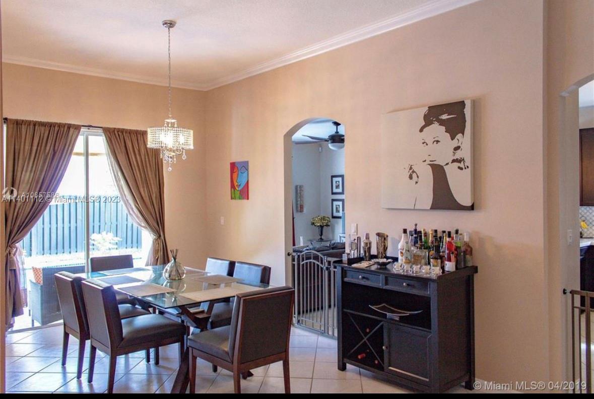 The Hammocks Miami, FL 33196 - Photo 4 of 9 a view of a dining room with furniture and a chandelier