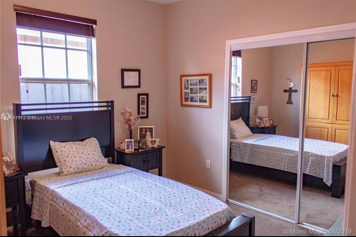 The Hammocks Miami, FL 33196 - Photo 6 of 9 a bedroom with a bed and wooden floor