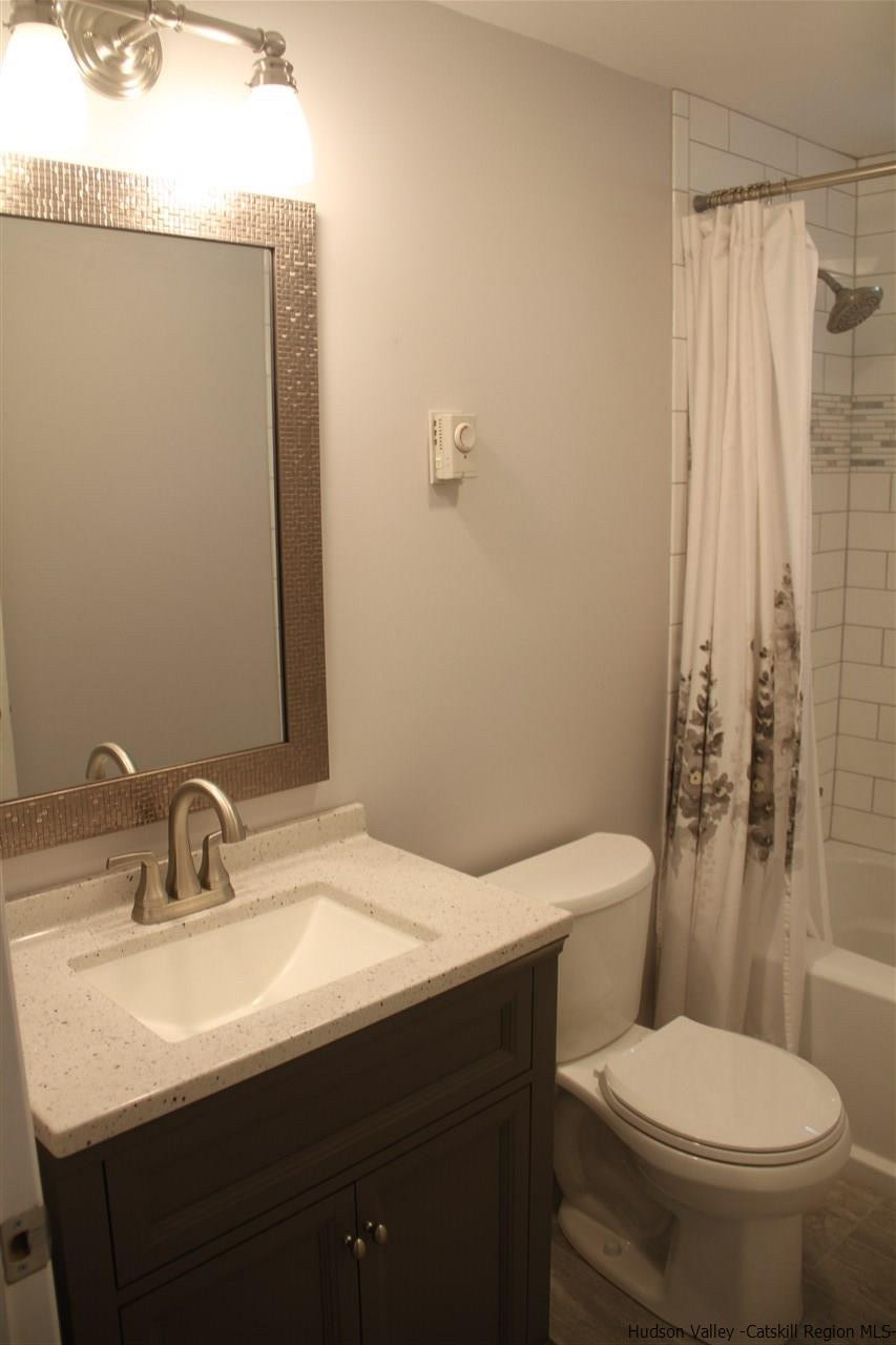 129 Bethel Ridge Road Catskill, NY 12414 - Photo 22 of 35 a bathroom with a sink a toilet and shower