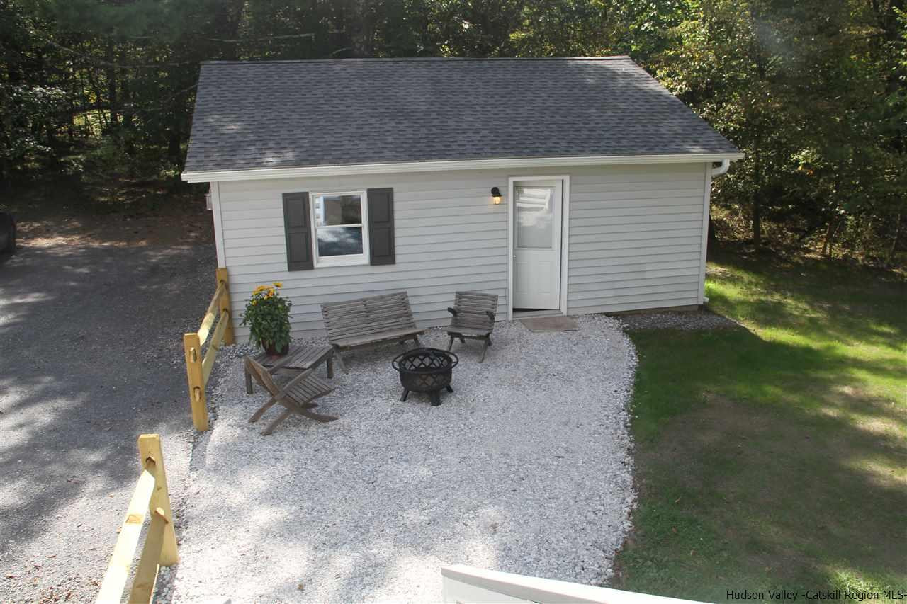 129 Bethel Ridge Road Catskill, NY 12414 - Photo 28 of 35 a backyard of a house with table and chairs