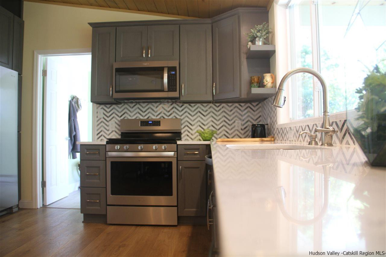 129 Bethel Ridge Road Catskill, NY 12414 - Photo 8 of 35 a kitchen with granite countertop a stove and a sink