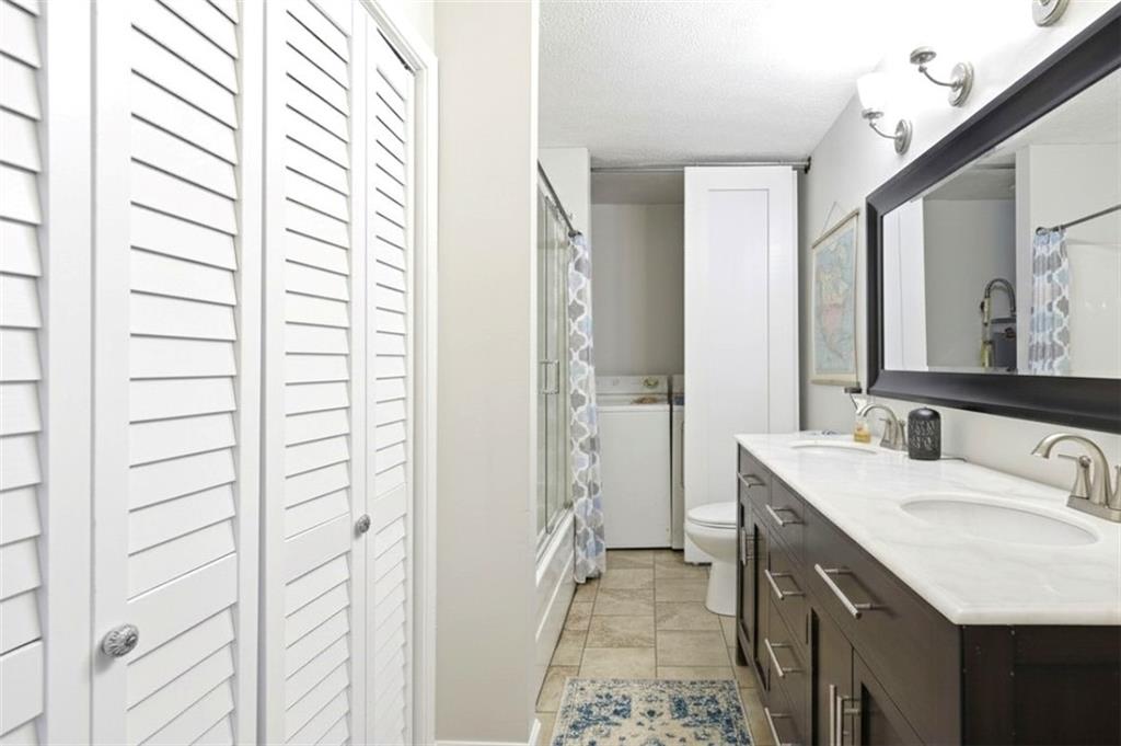 171 Northeast Broad Street Fairburn, GA 30213 - Photo 11 of 15 a bathroom with a sink and a mirror